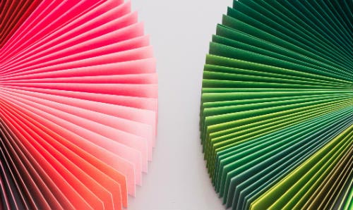 Two hand held fans open side by side