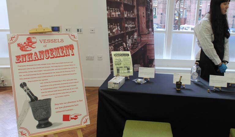 Photo of the exhibition stand that informs us that pharmacies developed from early herbalist shops.